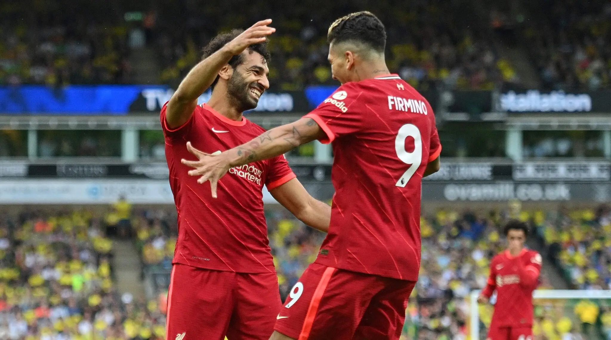 Liverpool’s Mohamed Salah and Roberto Firmino celebrate a goal