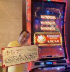 Roberto Arcueno shows the facsimile $1.5 million check