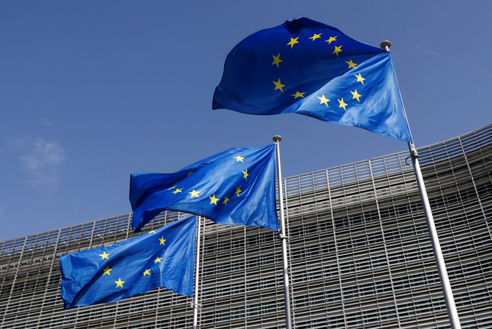 European Union flags fly in front of the European Commission headquarters