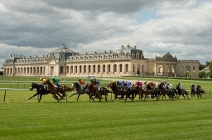 Horses come around a bend at Chantilly