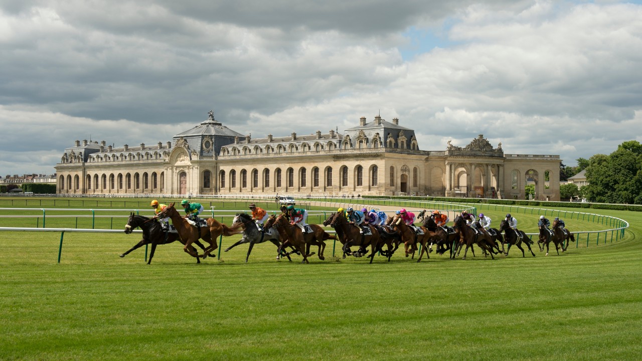 Horses come around a bend at Chantilly