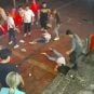 Two women lie on the ground after a group of men beat them up