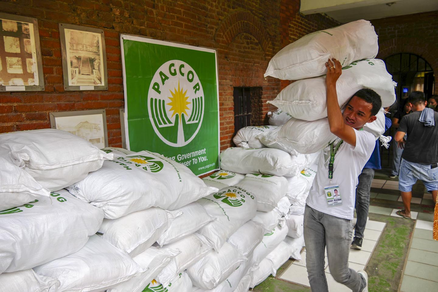 PAGCOR representative distributes relief packs to areas hit by Super Typhoon.