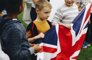 Group of kids holding a UK flag