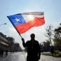 A man waves Chile's flag in public