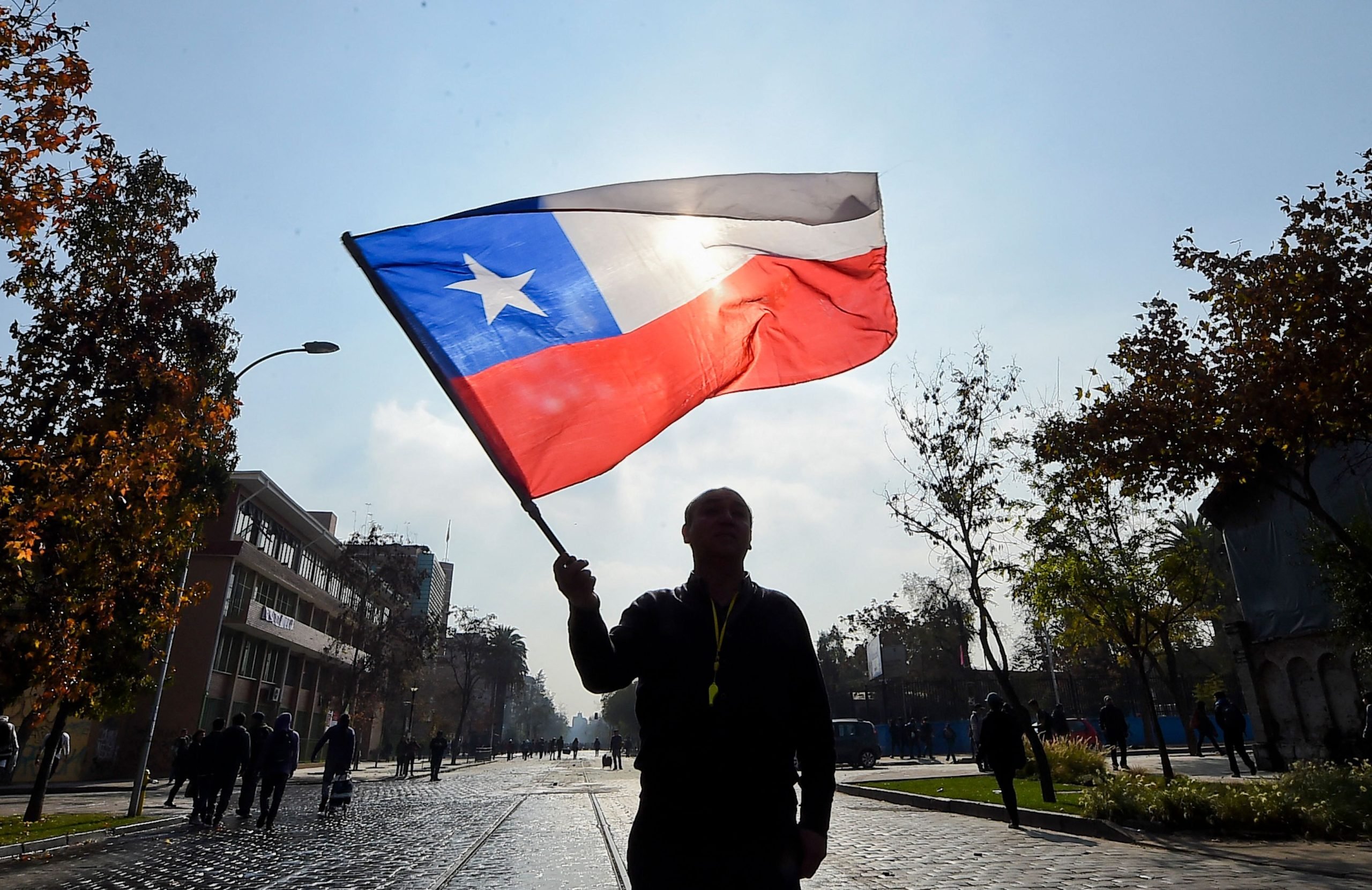 A man waves Chile's flag in public