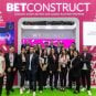 BetConstruct employees pose in front of a company booth at G2E