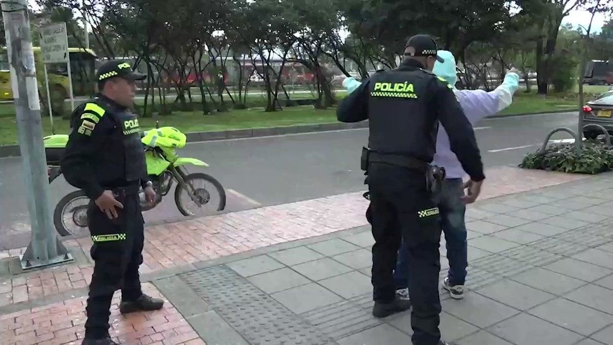 Colombian police search a suspect on the streets