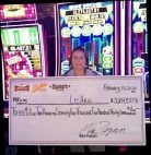 LeAnn W. holds a facsimile check from Carson Valley Inn Casino