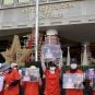 NagaWorld protestors hold signs supporting jailed union leader Chhim Sithar