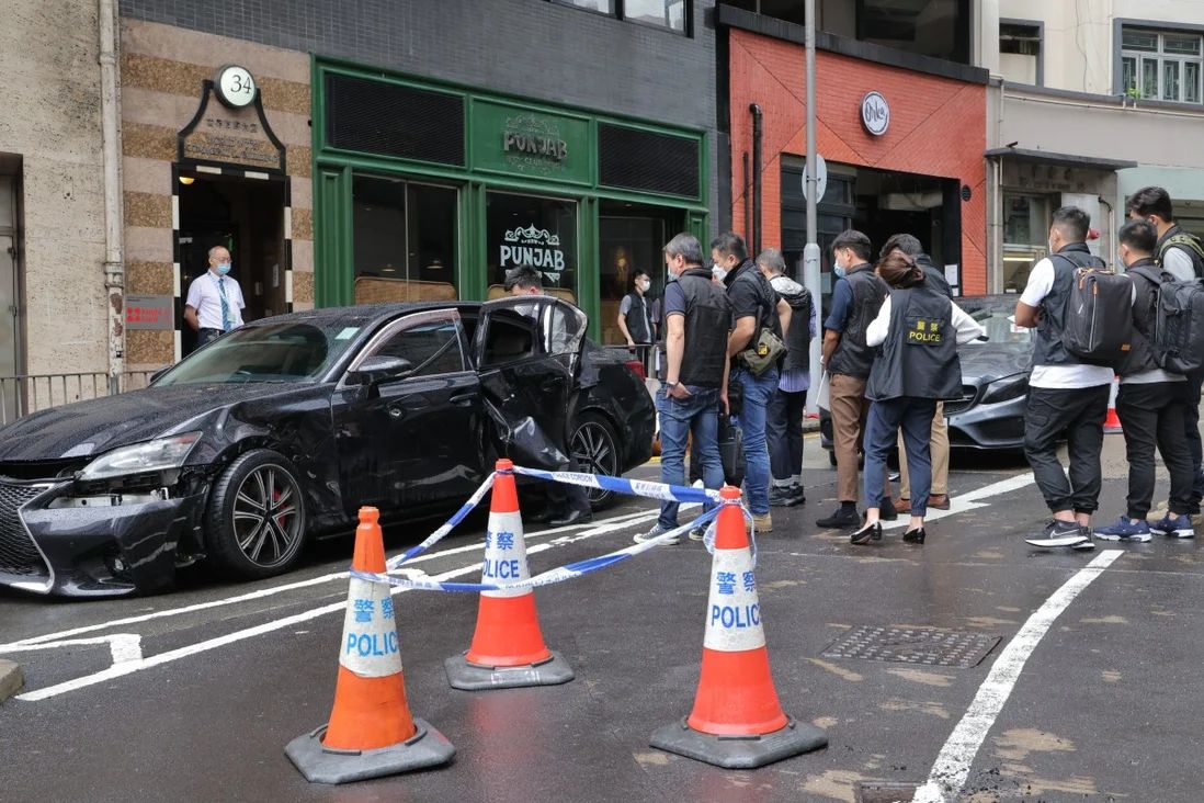 Hong Kong Police investigators inspect a vehicle involved in a triad-related fight