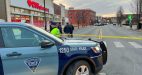 A police cruiser and police tape block the road near the MGM Springfield