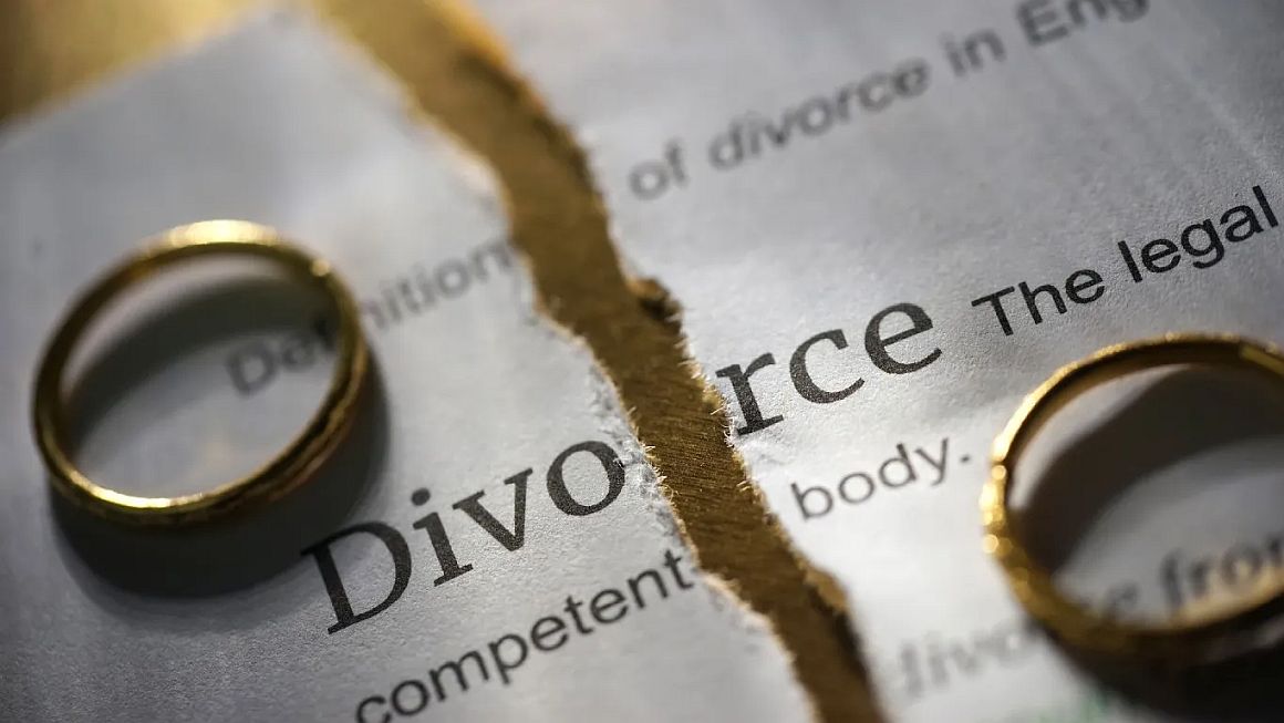A divorce decree with wedding bands