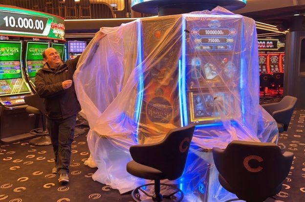 A worker unveils gaming machines at a new casino in Andorra