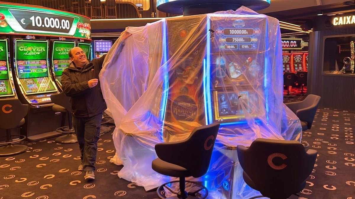 A worker unveils gaming machines at a new casino in Andorra