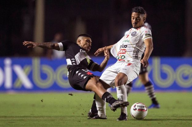 Brazilian soccer players battle for the ball on the field