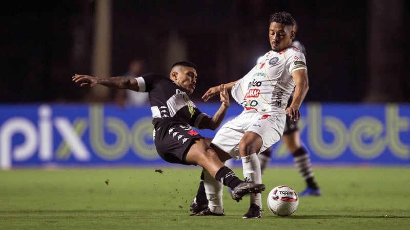 Brazilian soccer players battle for the ball on the field