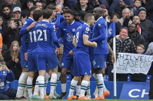 Chelsea FC players celebrate on the field.