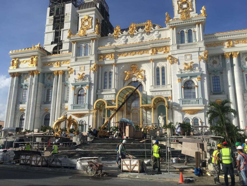 Construction workers work on the Imperial Palace casino in Saipan