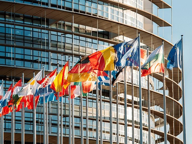Flags of the countries of the European Union fly over the headquarters of the EU