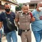 Plainsclothes police officers escort Wuttisak Phittakchan-im (center) to jail