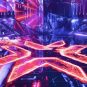 The Valorant logo shines on an eSports tournament stage