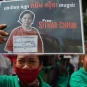 A supporter of Cambodia union leader Chhim Sithar holds up a placard outside Phnom Penh Municipal Court in Phnom Penh on May 25