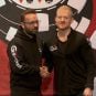 Jason Koon (right) shakes hands with Daniel Negreanu as he's announced as a new GGPoker ambassador.