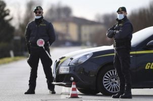 Officers with Italy's financial crimes police conduct a routine patrol