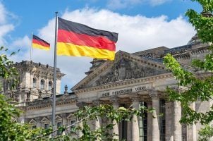 The German Flag of Unity flies in the national colors in front of the Reichstag Building
