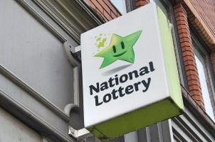 A National Lottery sign hangs outside a vendor's store