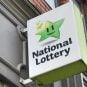 A National Lottery sign hangs outside a vendor's store
