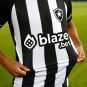 A player with Brazil's Botafogo soccer club shows off a jersey after Blaze became its primary sponsor