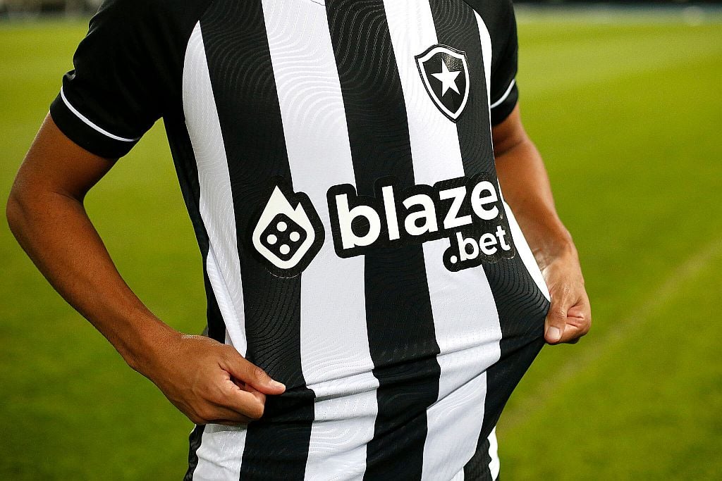 A player with Brazil's Botafogo soccer club shows off a jersey after Blaze became its primary sponsor