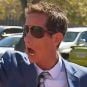 Mark Sebo gestures as he prepares to enter court on embezzlement charges
