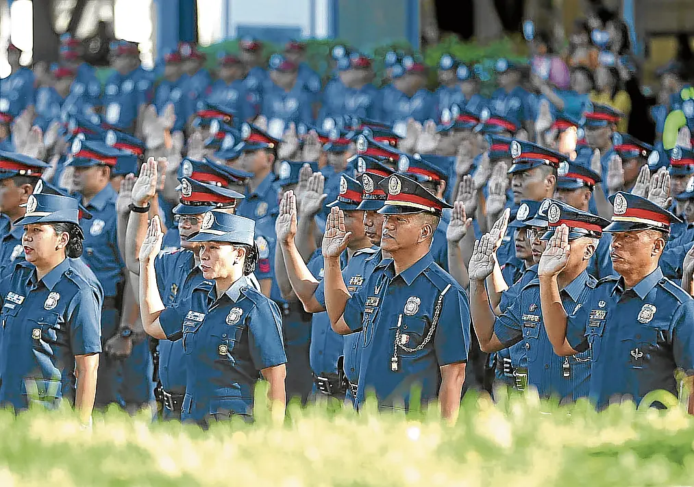 Philippine PNP police officers participate in a swearing-in ceremony