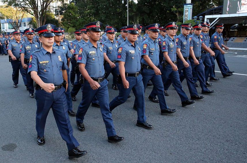 Philippine National Police officers march in formation