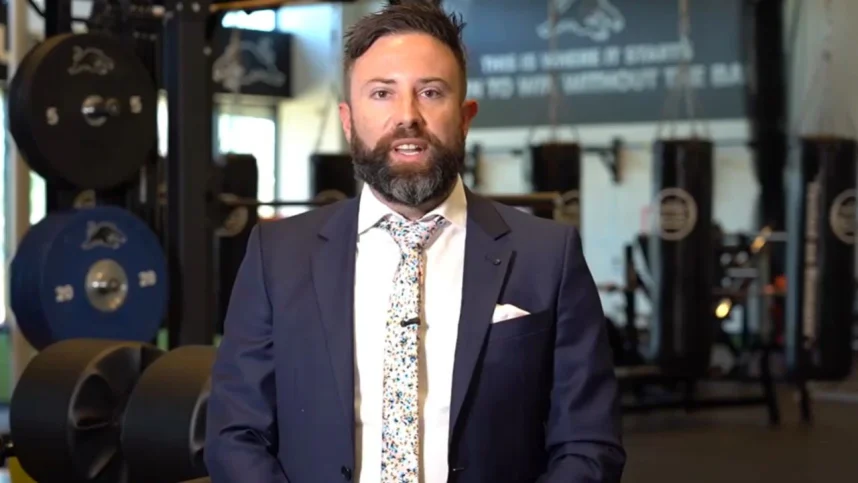 Australian accountant Ben Carter wearing a suit in a gym