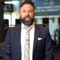 Australian accountant Ben Carter wearing a suit in a gym