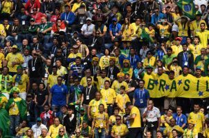 Brazilian soccer fans watch a game in a stadium