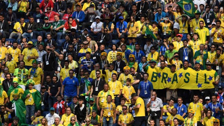 Brazilian soccer fans watch a game in a stadium