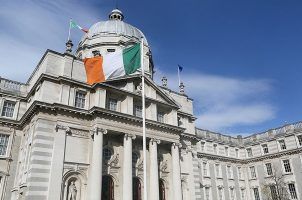 The Irish national flag flies outside the Government Buildings in Dublin