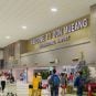 Travelers walk through the Don Mueang International Airport in Bangkok, Thailand