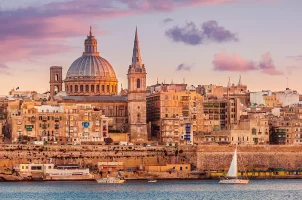 Valletta, Malta, skyline at sunset with the Carmelite Church dome and St. Paul's Cathedral
