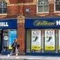 A person walks by a William Hill shop
