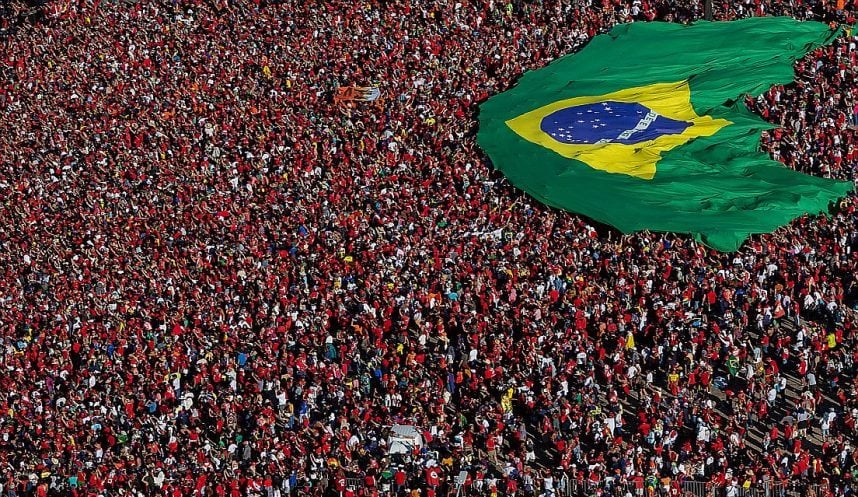 Brazilians gather and display a Brazilian flag during the presidential inauguration ceremony in Brasilia on New Year's Day 2023