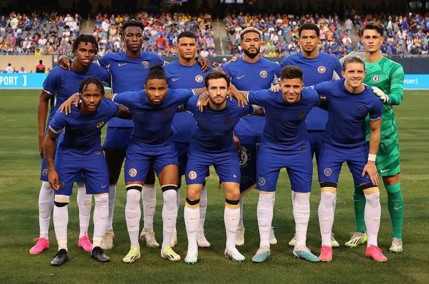 Chelsea FC players pose for a photo with no sponsor on the front of their jerseys