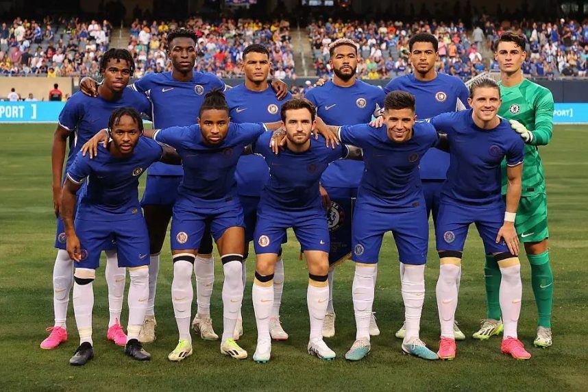 Chelsea FC players pose for a photo with no sponsor on the front of their jerseys