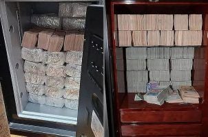Large stacks of cash found by Singapore police during recent raids