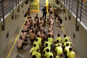 Prisoners sit on the floor of the Changi Prison in Singapore